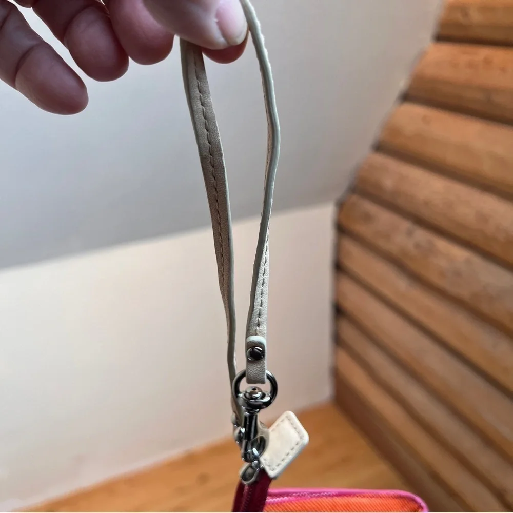 COACH WRISTLET. Cute orange,red,blue&cream stripe w/lots of pockets. 4”X7-½”